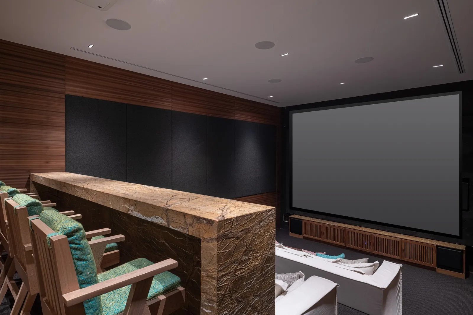 The private cinema with tiered sofas and a big screen