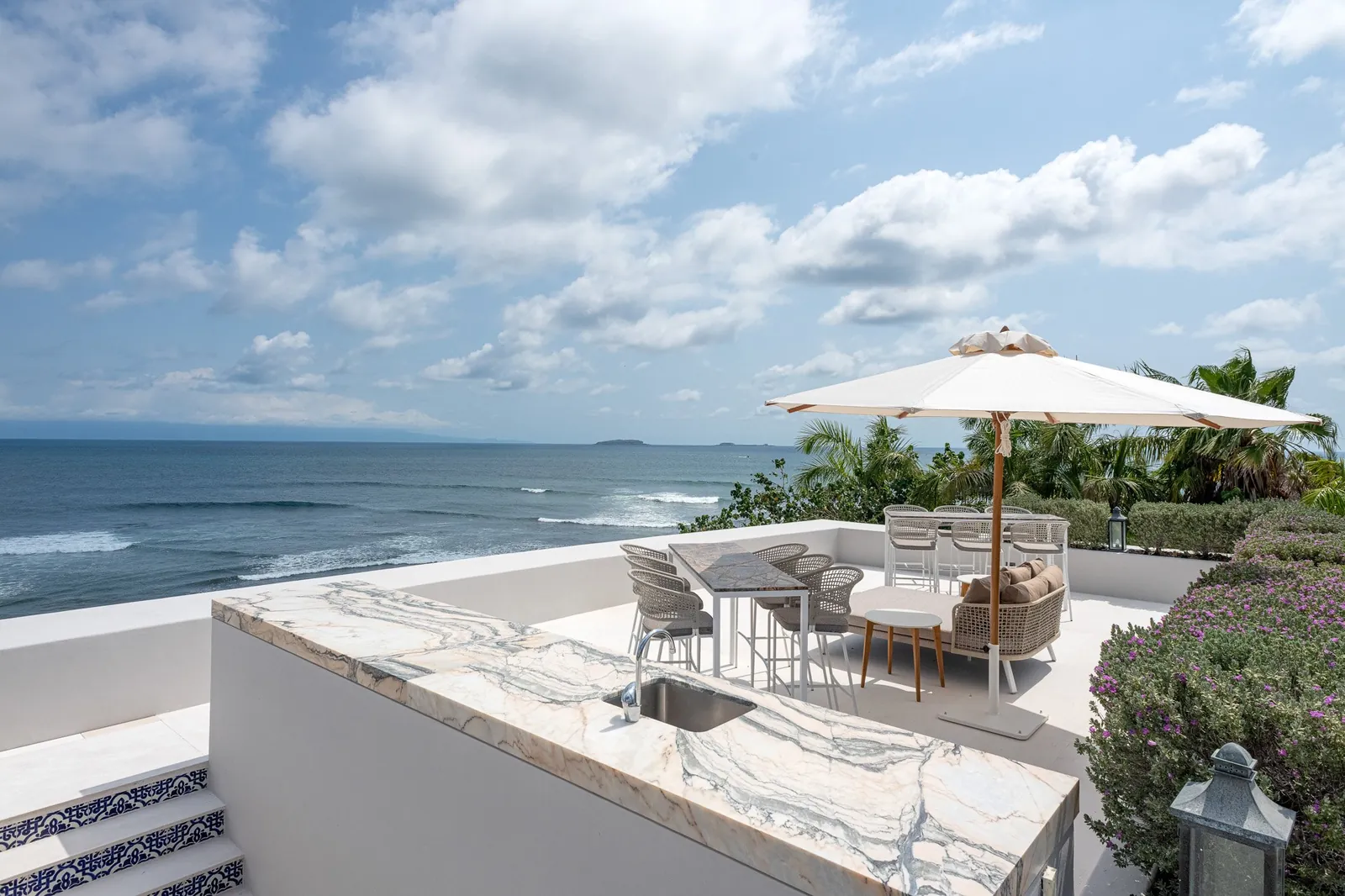 The rooftop terrace bar with the ocean and the islands on the horizon