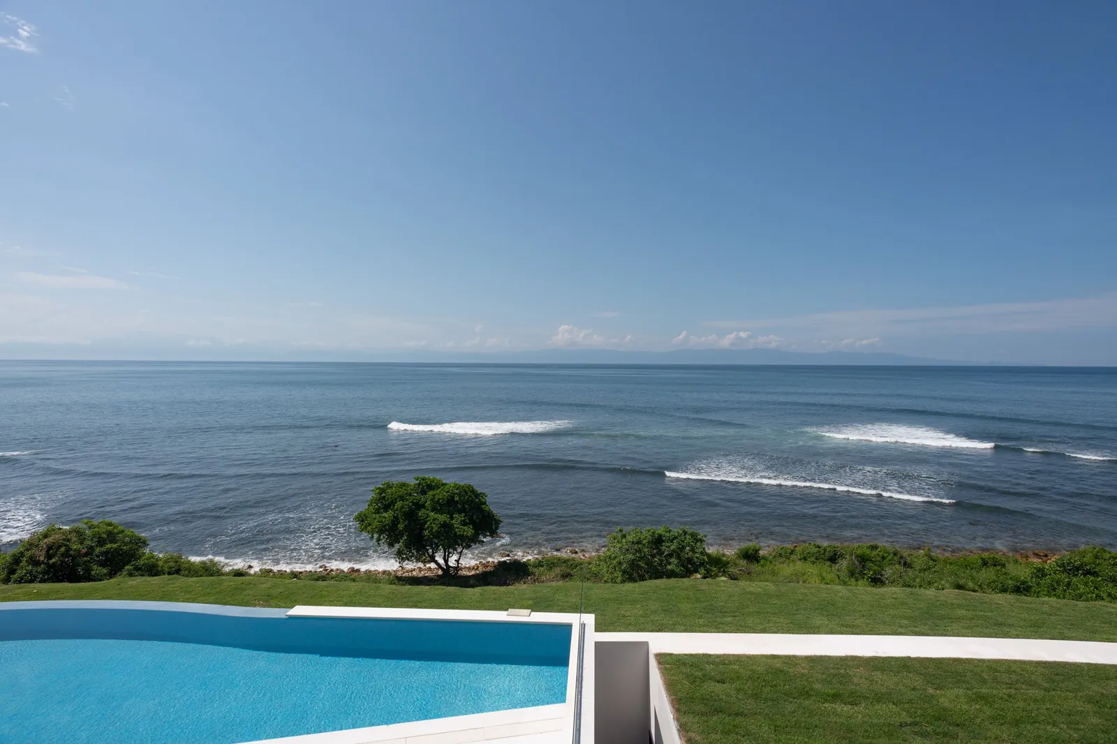 Waves breaking off the point below the villa's lawn
