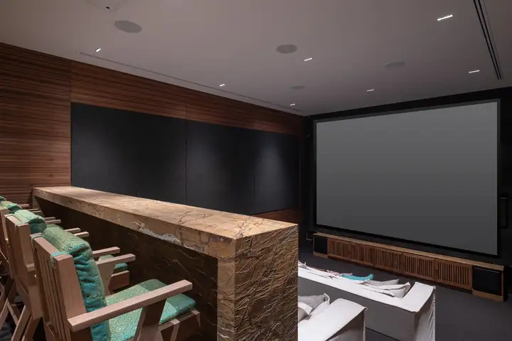 The private cinema with tiered sofas and a big screen