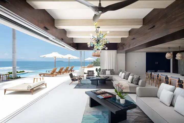 The long living room and bar, the ocean framed at one end
