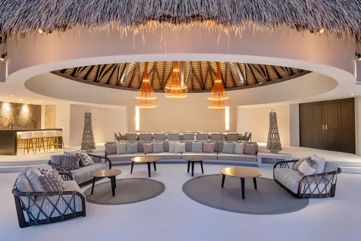 The palapa lounge lit at night beneath its thatched dome