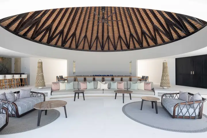 The round palapa lounge and its long banquette by day
