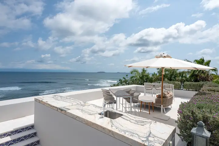 The rooftop terrace bar with the ocean and the islands on the horizon