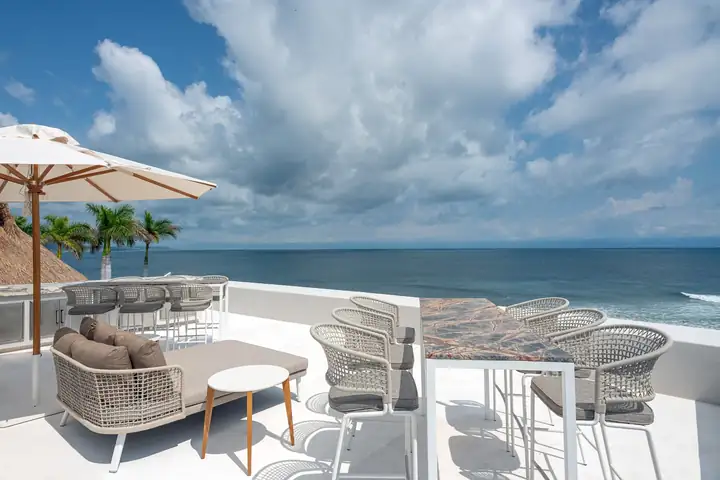 Lounge chairs and the bar on the rooftop terrace