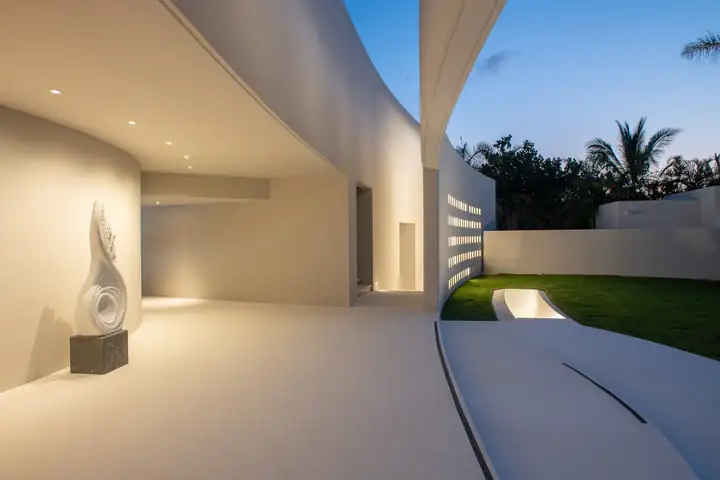 The curving white entrance courtyard and its sculpture
