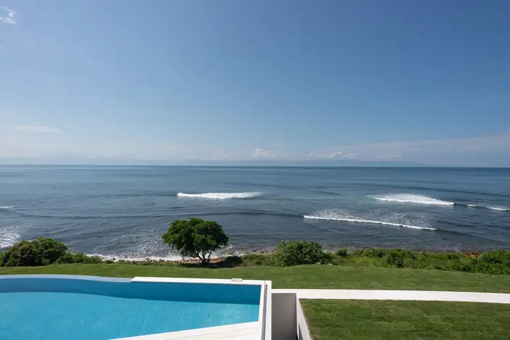 Waves breaking off the point below the villa's lawn